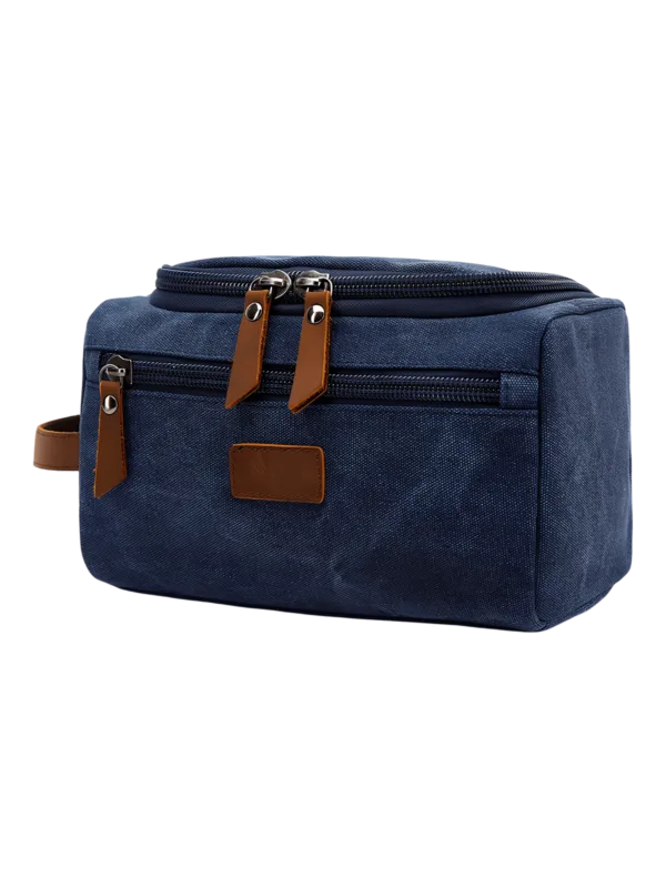 Trousse de toilette homme en toile avec empiècements cuirs et pochette extérieure couleur unie modèle bleu Trousse de toilette homme en toile avec empiècements cuirs et pochette extérieure couleur unie modèle bleu